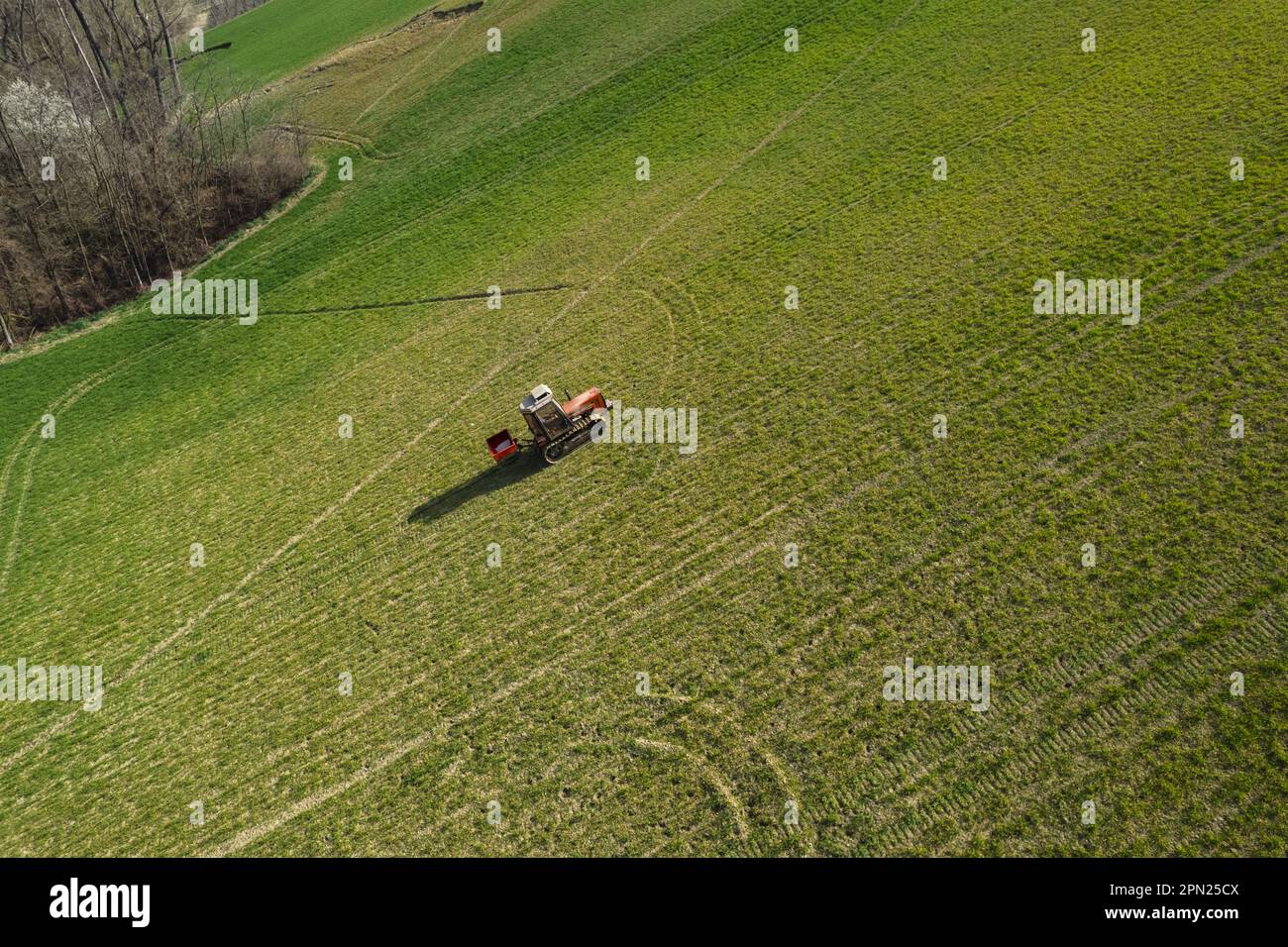farmer driving uphill crawled tractor in the farm during spring season