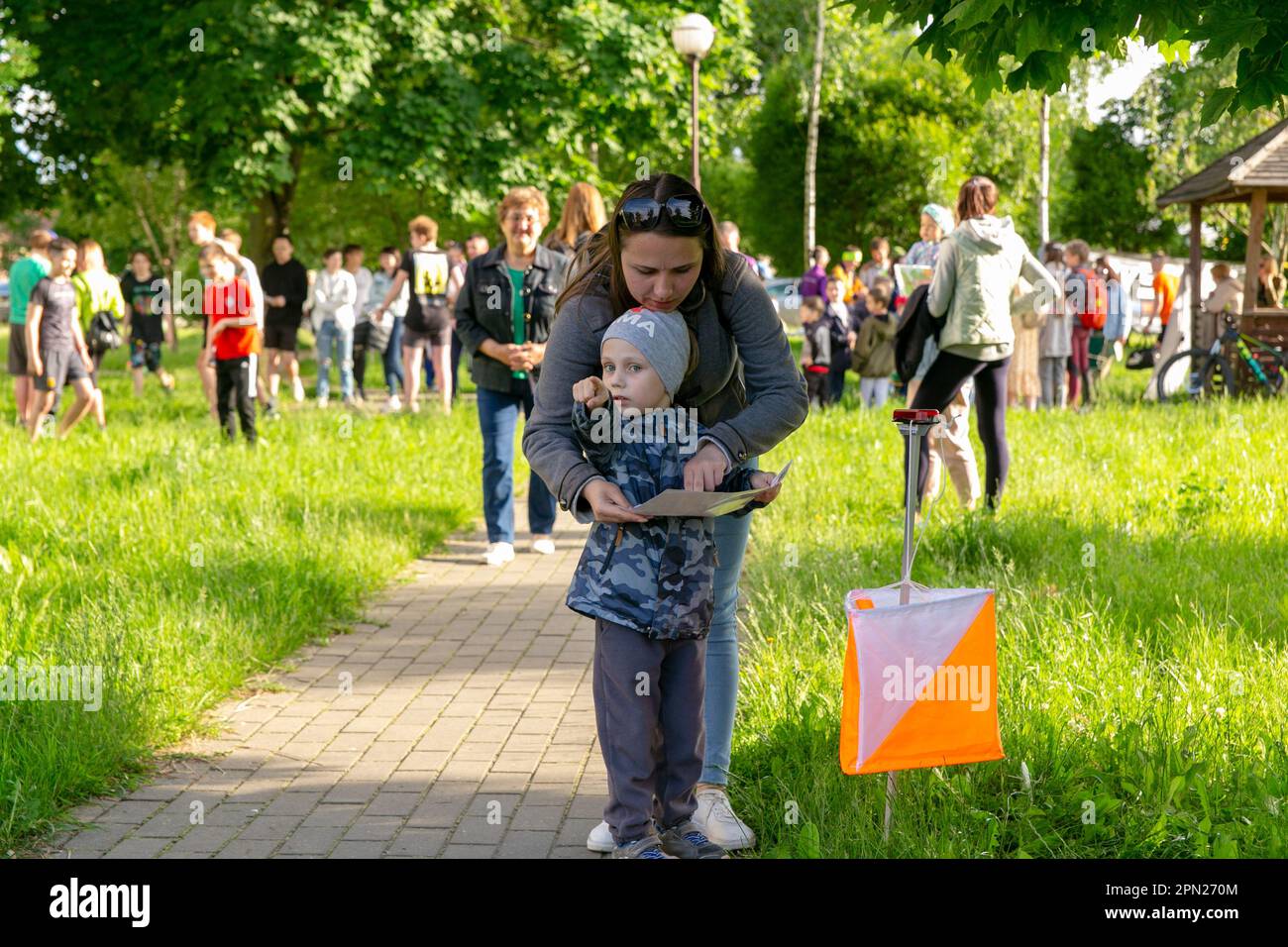 Grodno, Belarus - 15 June, 2022: Training of the Veras orienteering club . A woman with her daughter at the start of the route check the map and choos Stock Photo