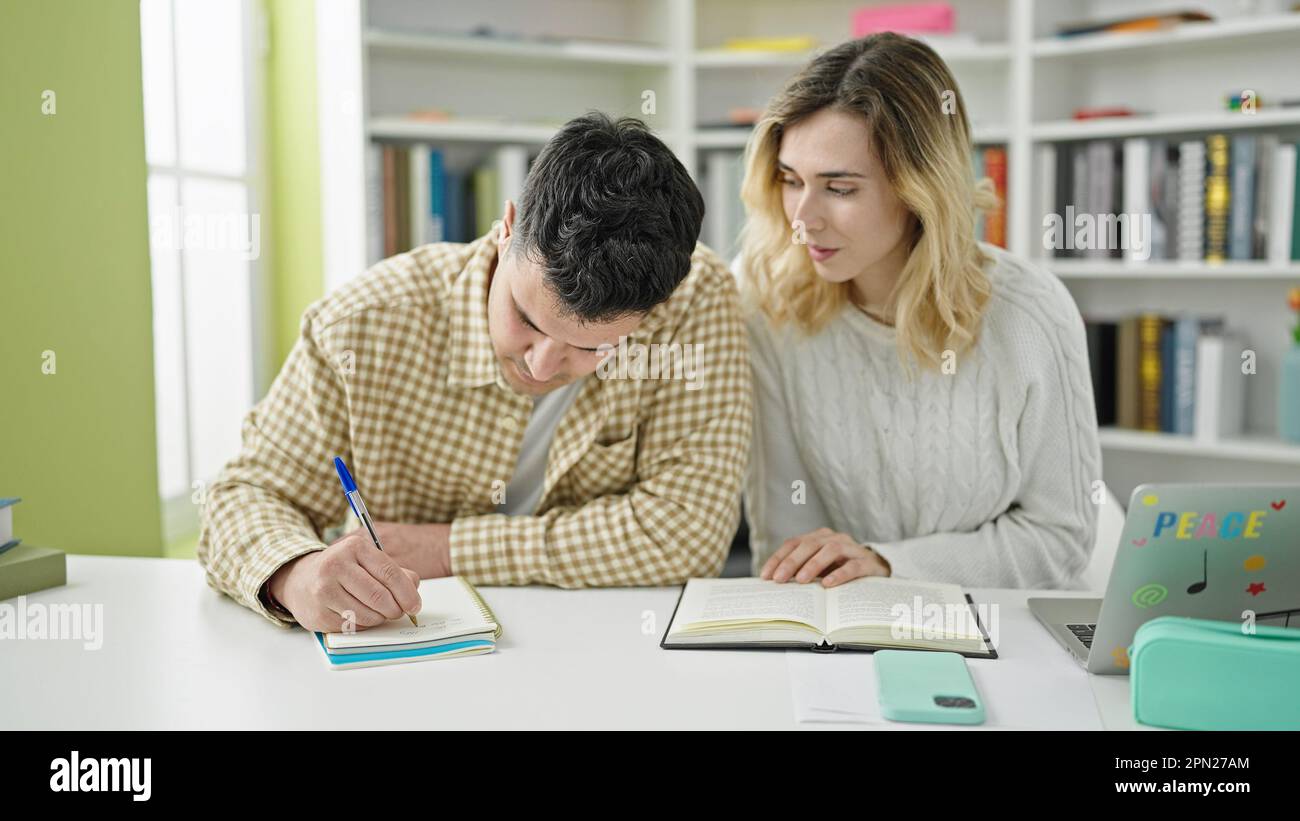 Man and woman students studying together at library university Stock ...