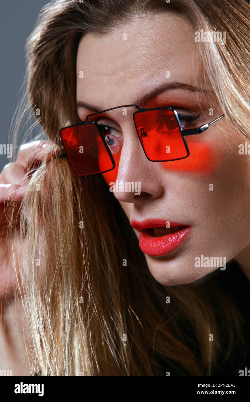 Portrait of a girl with red glasses Stock Photo - Alamy