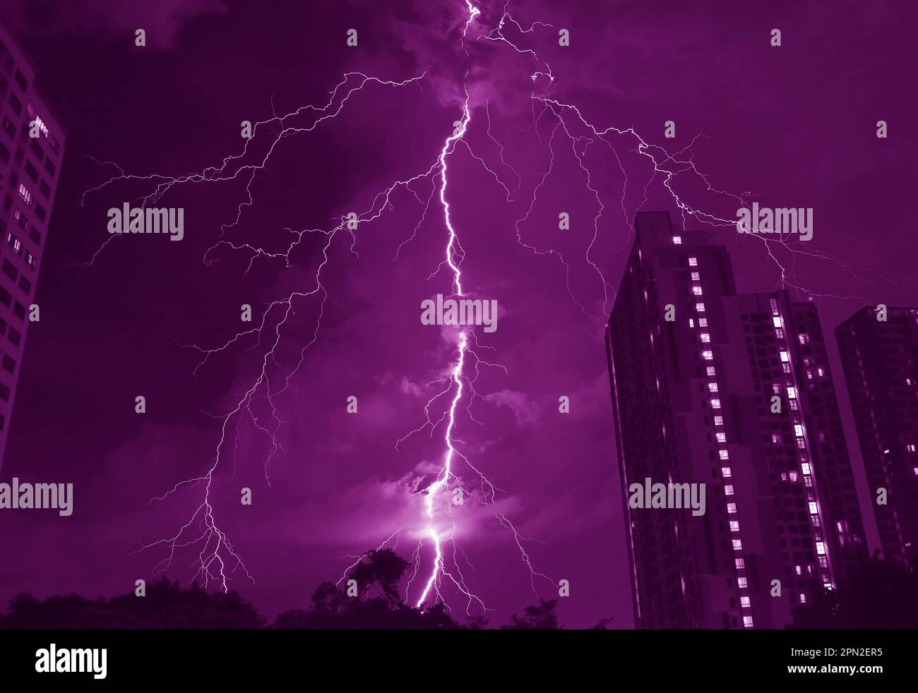 Pop Art Surreal Style of Amazing Lightning Strikes in Dark Purple Colored Urban Night Sky Stock Photo