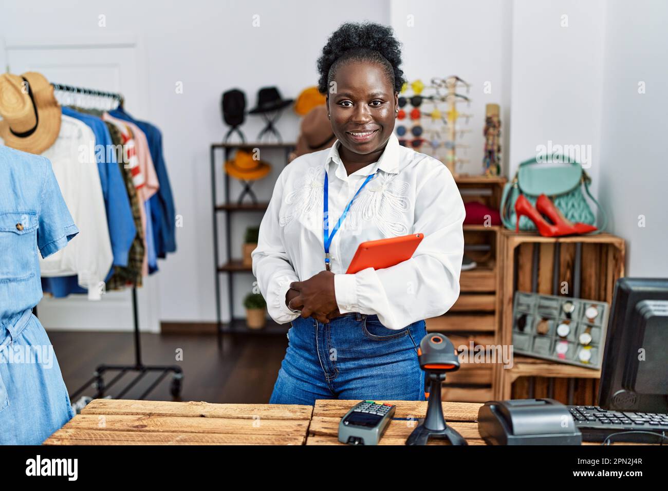 Young african american woman shopkeeper smiling confident holding ...