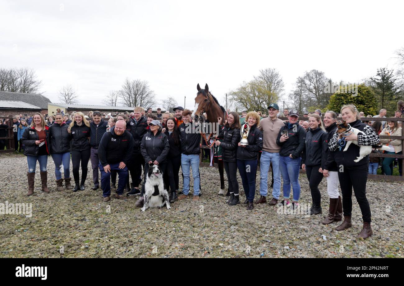 Owners and stable staff pose with Corach Rambler during the Randox