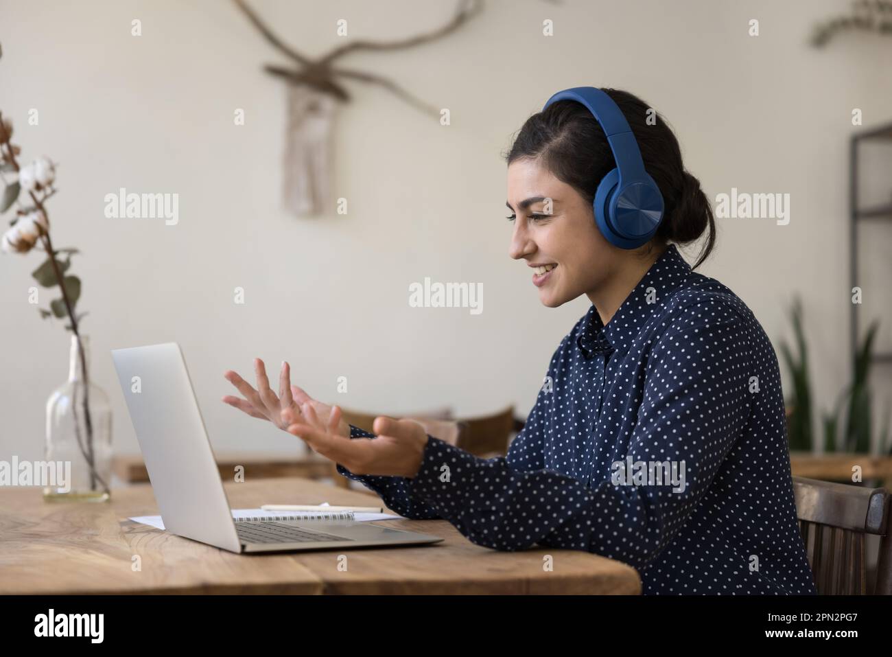 Indian woman in headphones take part in videocall at home Stock Photo ...