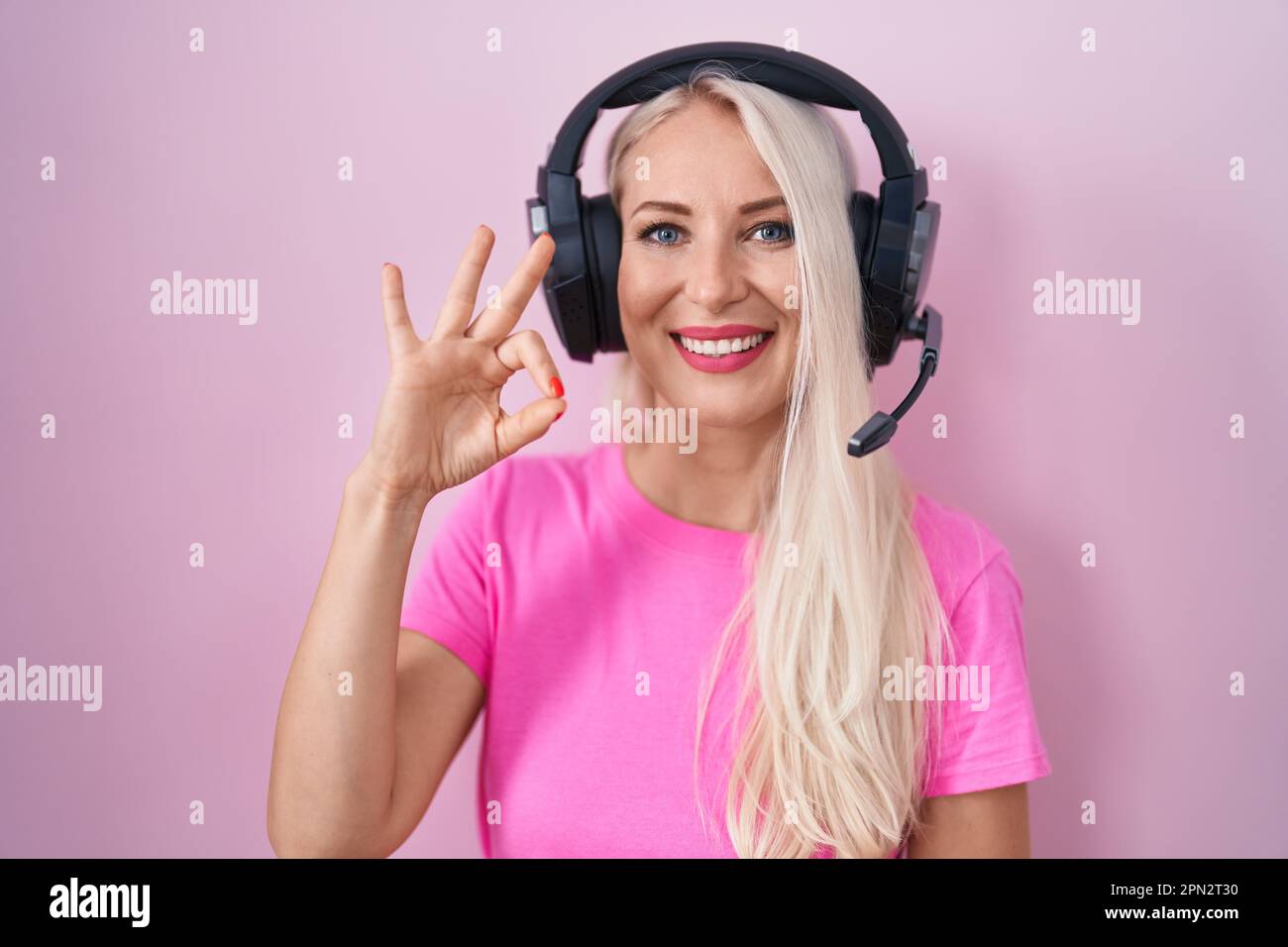 Caucasian woman listening to music using headphones smiling positive ...