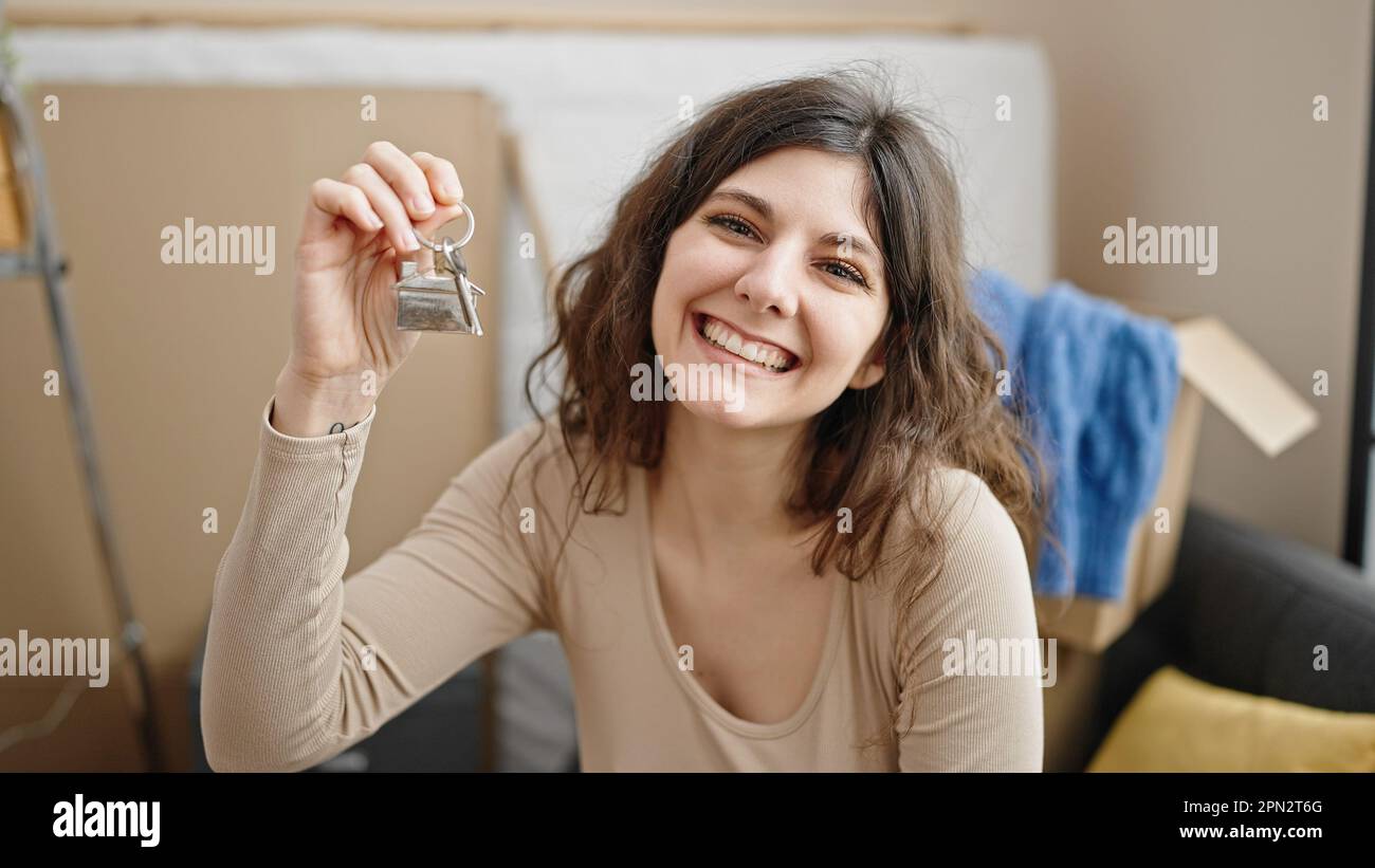 Young beautiful hispanic woman smiling confident holding new house keys ...