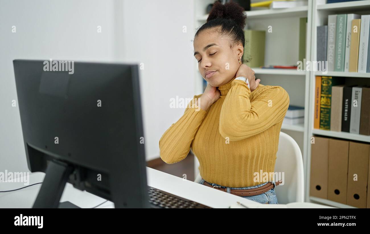 Young african american woman student using computer stressed at the ...