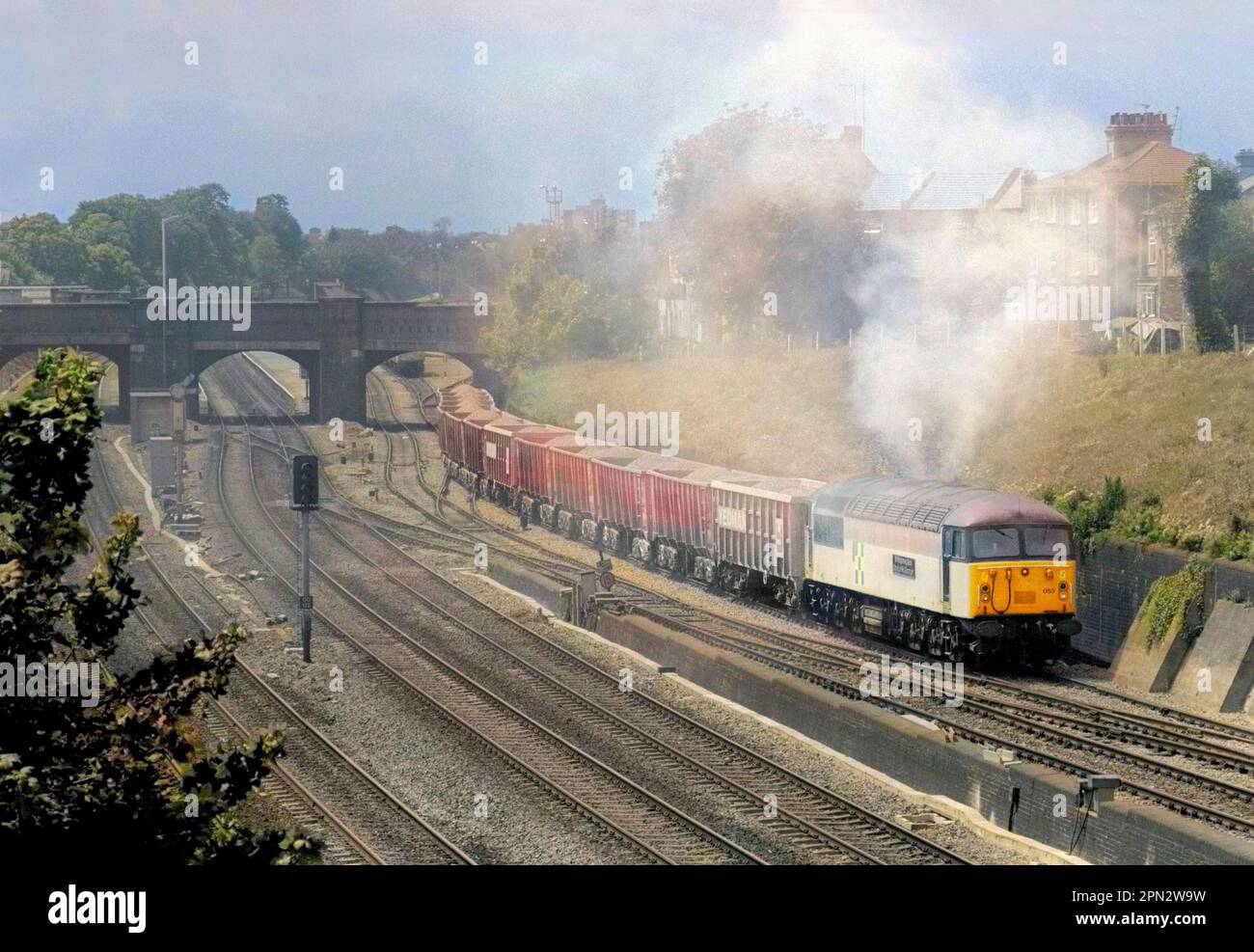 A Class 56 diesel locomotive number 56053 working a loaded stone makes a smokey ascent of Acton Bank on the 10th June 1991. Stock Photo