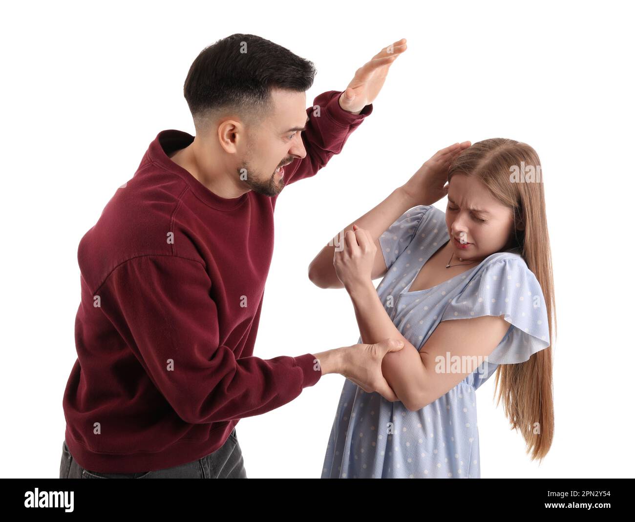 Angry young man hurting his wife on white background. Domestic violence