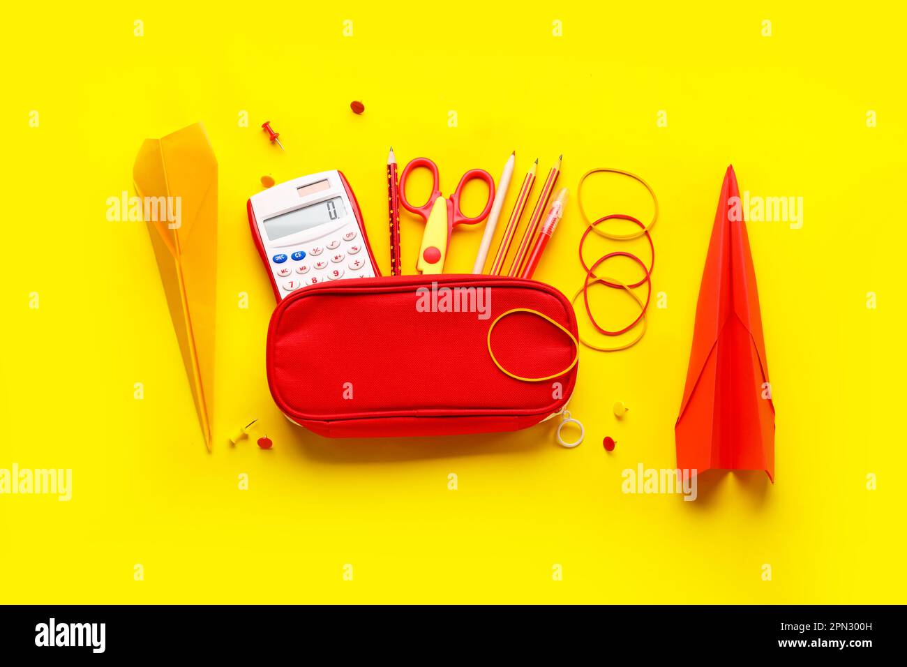Composition with stationery supplies and paper planes on yellow ...