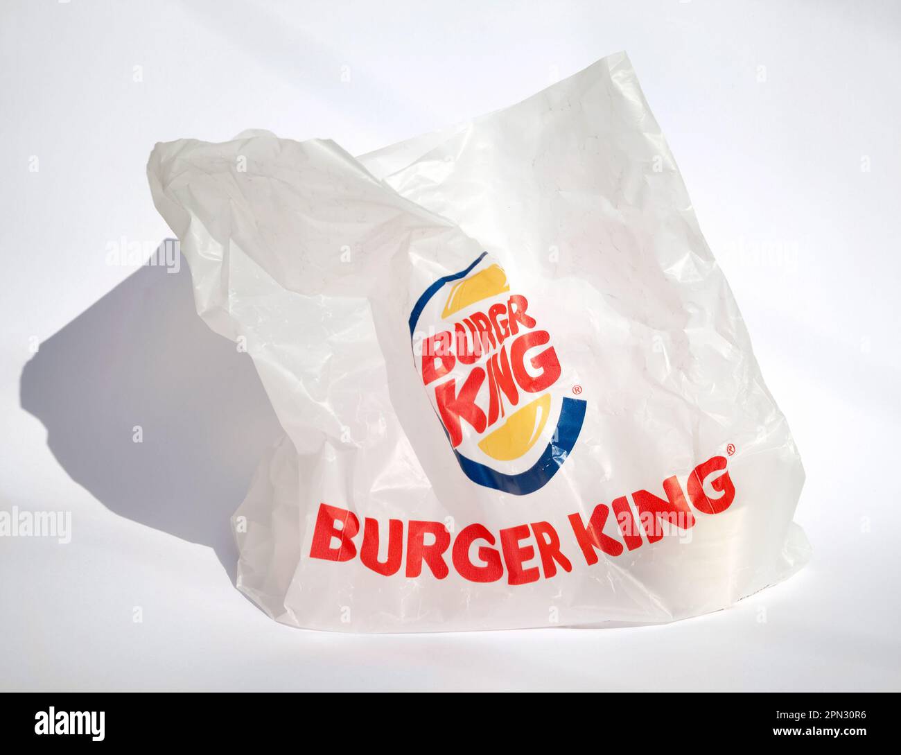 Ho Chi Minh City, Vietnam - April 8, 2023: Empty plastic bag with red and yellow Burger King logo isolated on white. Trash left after ordering takeout Stock Photo