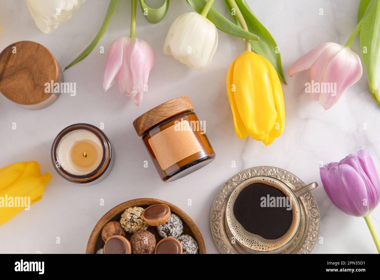 Soy aroma candle in a glass jar with a wooden lid. Copy space label ...