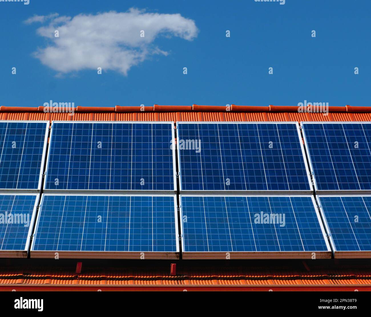 roof installed photovoltaic PV sun collector solar panels. sloped residential roof. alternative and clean and renewable energy generation. environment Stock Photo