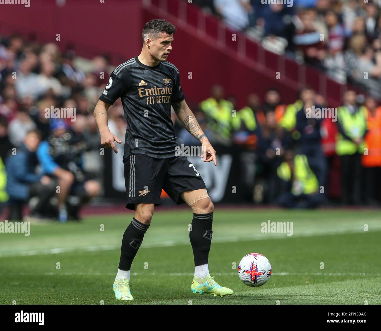 Granit Xhaka #34 of Arsenal with the ball during the Premier League match West Ham United vs Arsenal at London Stadium, London, United Kingdom, 16th April 2023  (Photo by Arron Gent/News Images) Stock Photo