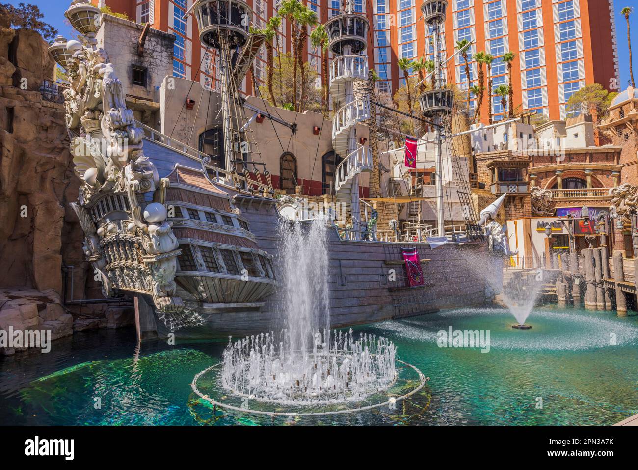 Beautiful view of territory of Treasure Island hotel on Strip with fountains in pond and pirate ship. Las Vegas. USA. Stock Photo
