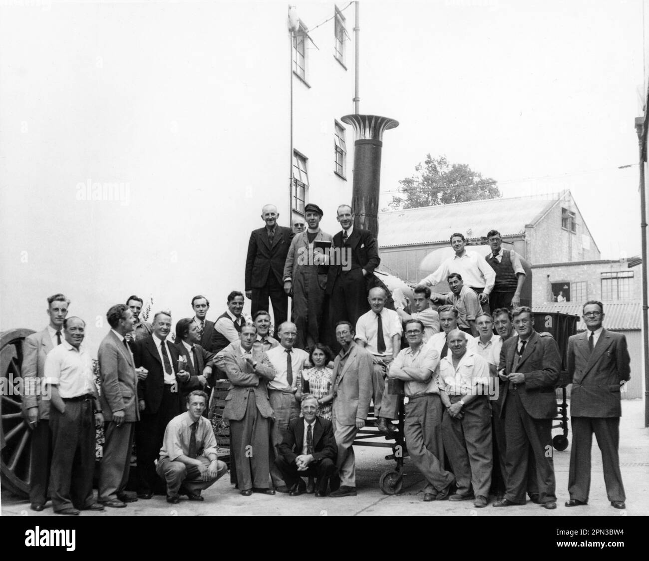 Director CHARLES CRICHTON (6th from left standing) and Film Crew at Ealing Studios with the genuine 1838 steam locomotive Lion used in THE TITFIELD THUNDERBOLT 1953 director CHARLES CRICHTON original screenplay T.E.B. Clarke music Georges Auric producer Michael Truman An Ealing Studios Michael Balcon Production / General Film Distributors (GFD) Stock Photo
