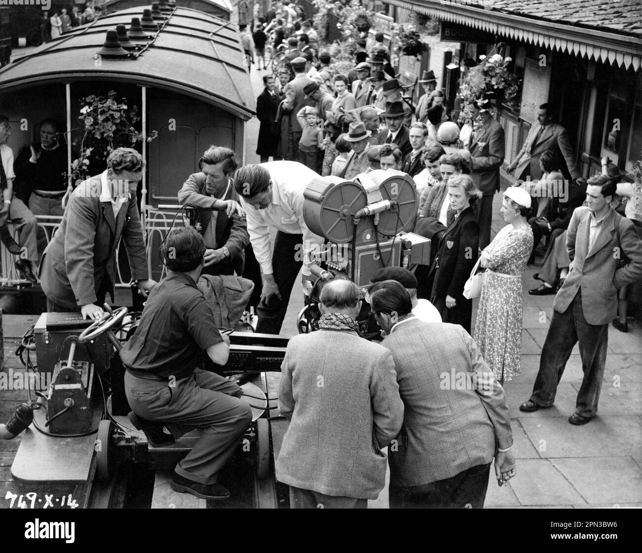 Director CHARLES CRICHTON and Camera / Movie Crew on set location candid filming a scene at railway station for THE TITFIELD THUNDERBOLT 1953 director CHARLES CRICHTON original screenplay T.E.B. Clarke music Georges Auric producer Michael Truman An Ealing Studios Michael Balcon Production / General Film Distributors (GFD) Stock Photo