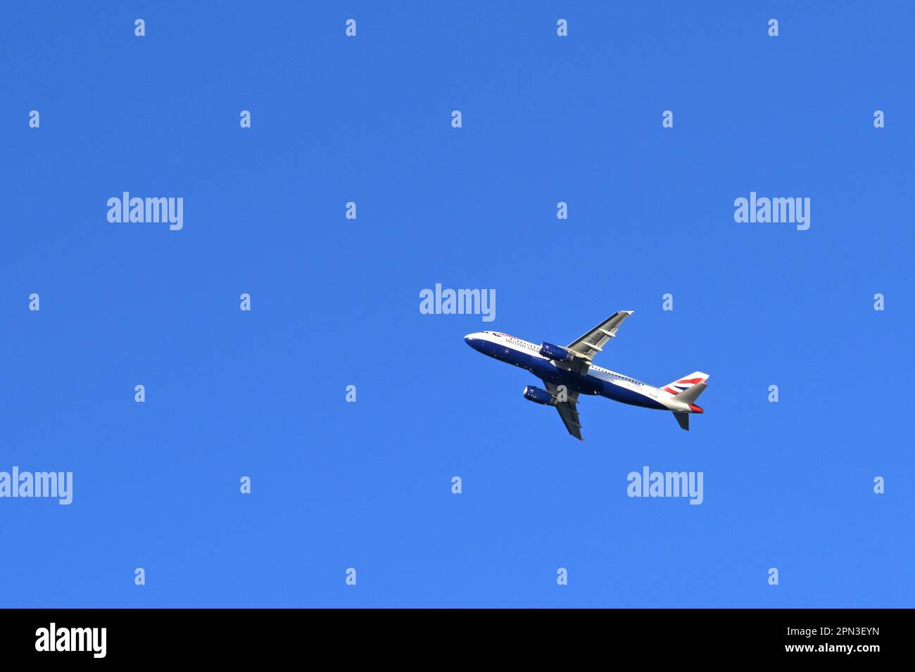 London, England - January 2023: British Airways Airbus jet climbing after take off from Heathrow Airport isolated against a deep blue sky Stock Photo