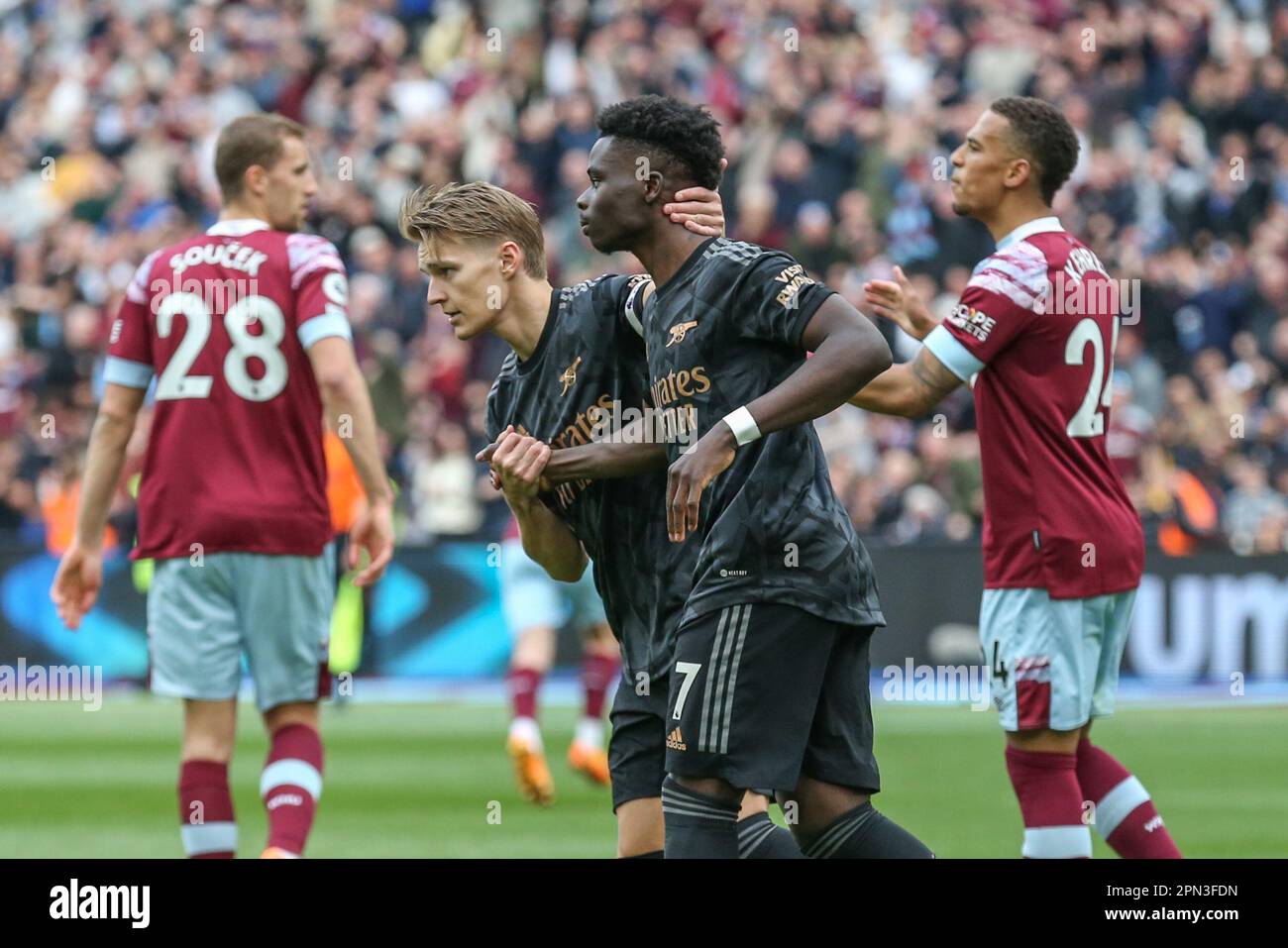 Martin Ødegaard #8 of Arsenal consoles Gianluca Scamacca #7 of West Ham United after he misses a penalty during the Premier League match West Ham United vs Arsenal at London Stadium, London, United Kingdom, 16th April 2023  (Photo by Arron Gent/News Images) Stock Photo