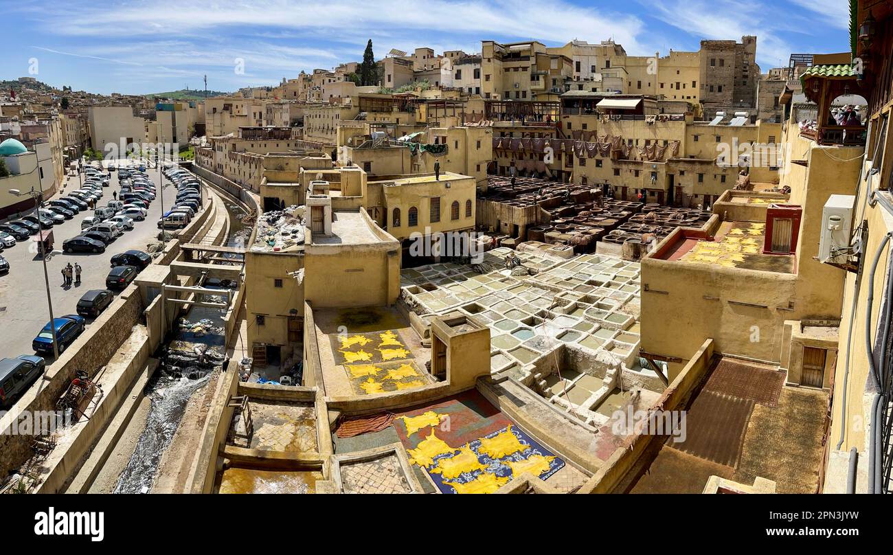 Fes, Morocco, Africa: aerial view of the tannery where workers dye the leather in stone tubs arranged in a honeycomb pattern and filled with colours Stock Photo