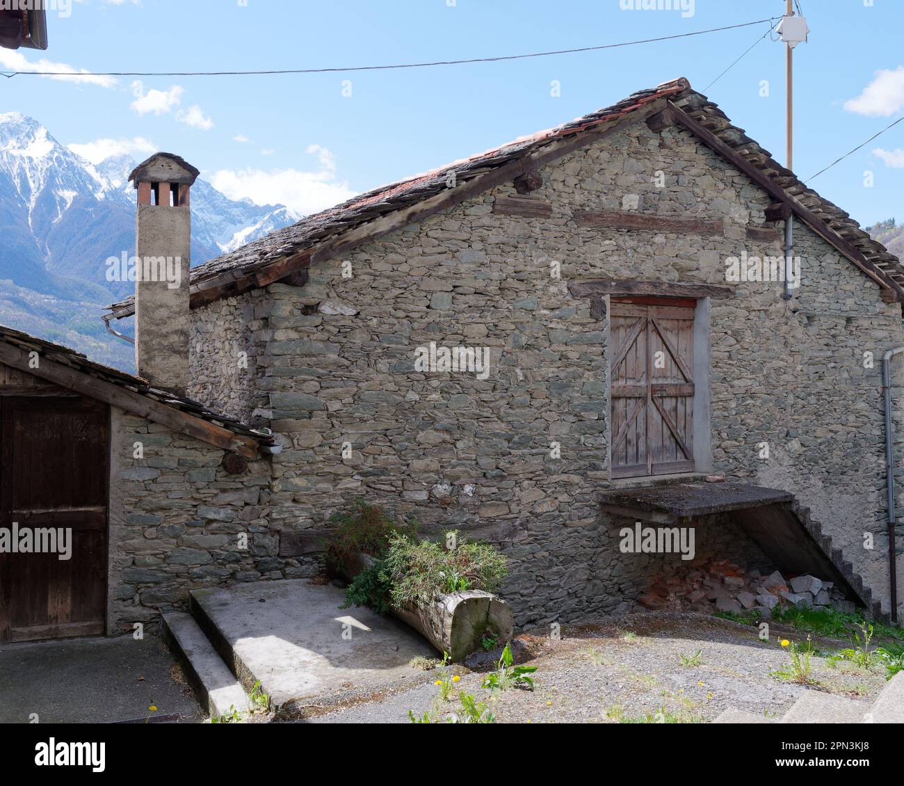 Traditional stone built property with chimney stack near Nus in the Aosta Valley, Italy Stock Photo