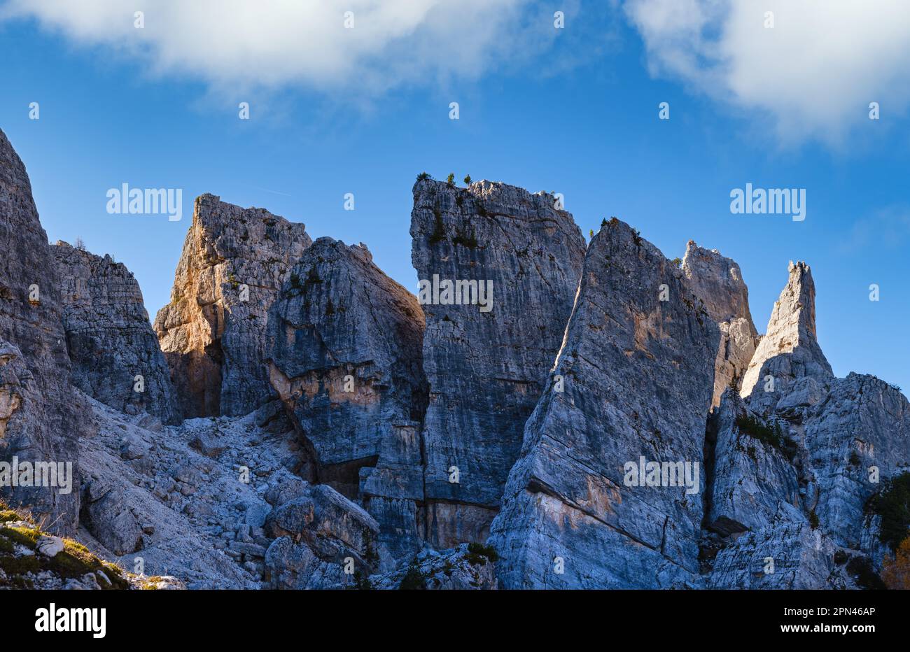 Sunny autumn alpine Dolomites rocky  mountain scene, Sudtirol, Italy. Cinque Torri (Five pillars or towers) rock famous formation.  Climbers unrecogni Stock Photo