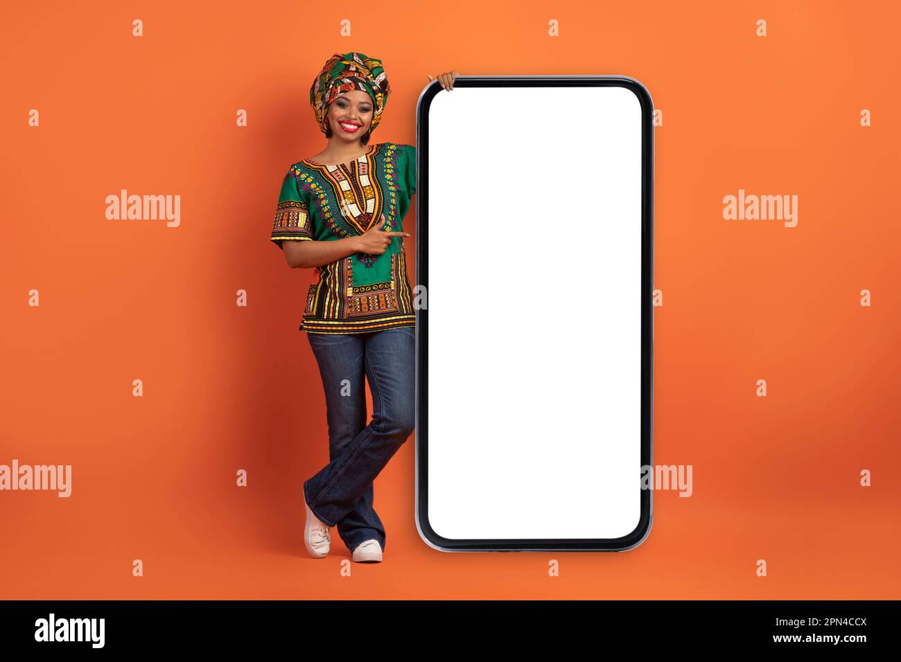 Cheerful pretty african woman pointing at smartphone blank screen Stock ...