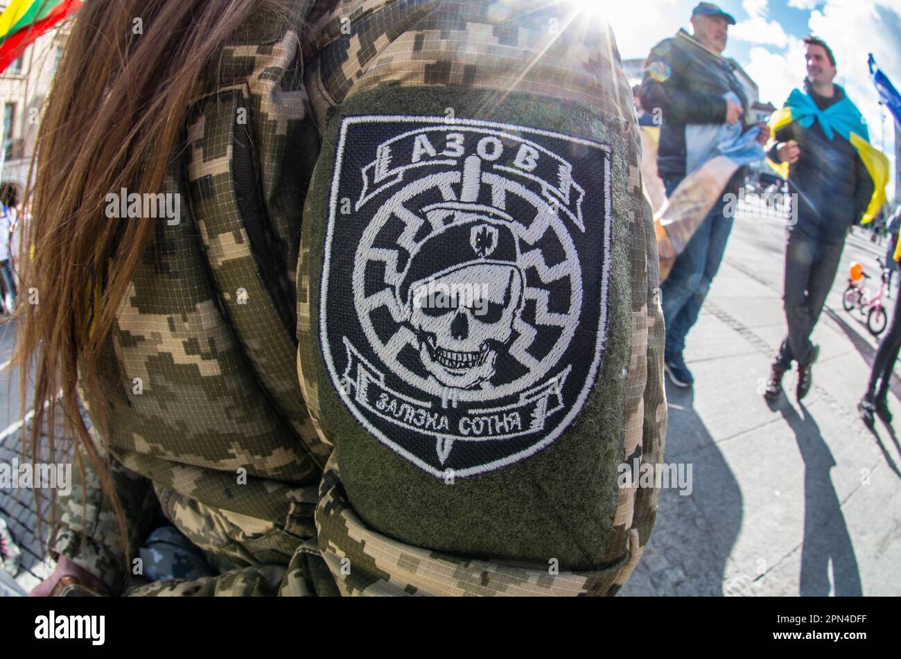 Munich, Bavaria, Germany. 25th Mar, 2023. A demonstrator in Munich, Germany wears patches of the former Azov Battalion after holding a speech about the Azovstal defenders of Mariupol, some of whom are still in Russian captivity. The former Azov Battalion was converted to the Azov Regiment and the highly taboo Wolfsangel displayed here was changed and forbidden. Such displays in Germany are currently isolated incidents and there is currently no evidence of neonazi influence at the demos. Many who demonstrate for the plight of the Azovstal defenders conflate them with the Azov Regiment who were Stock Photo