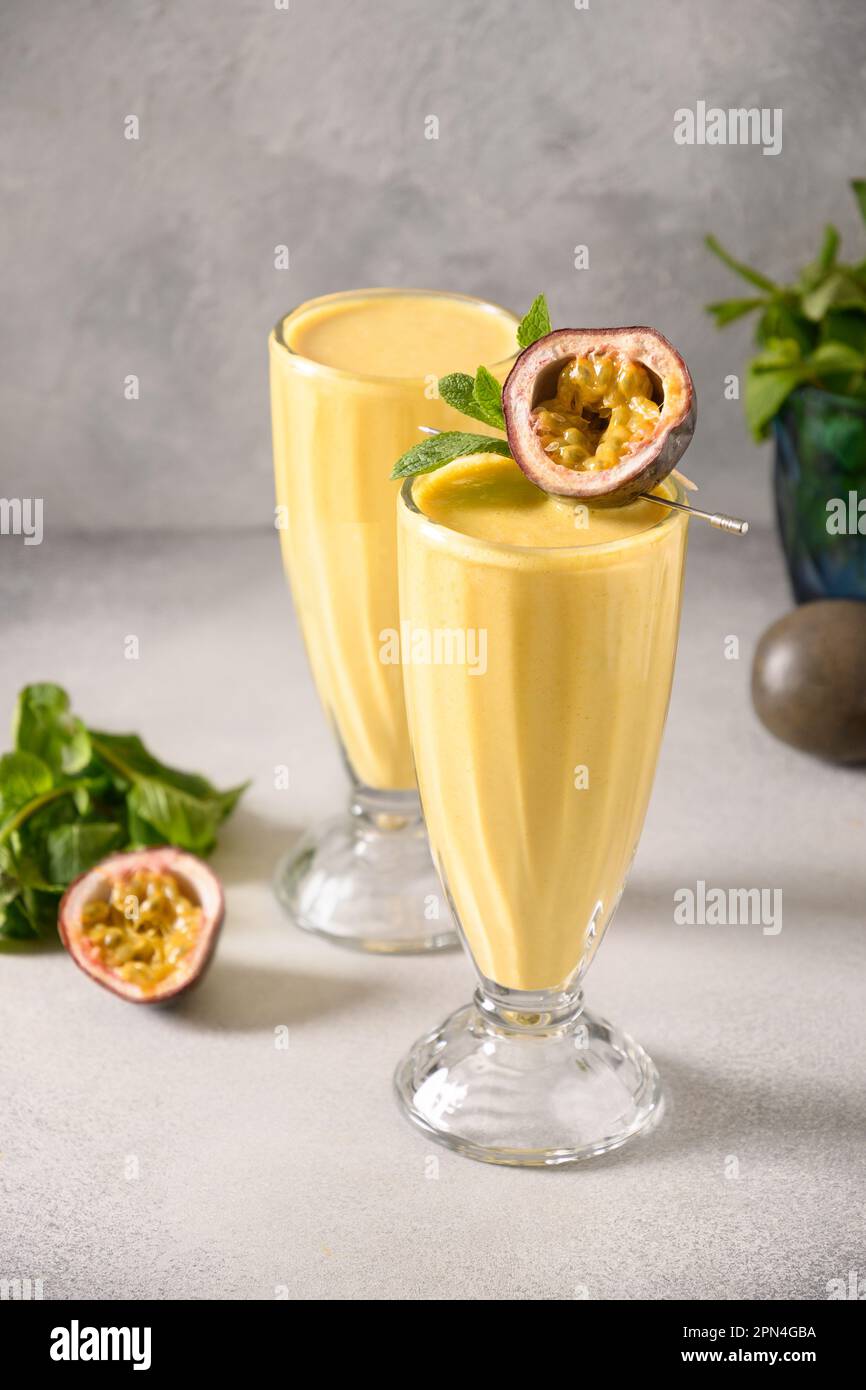 Indian two Passion Fruit Lassi on gray background. Vertical format
