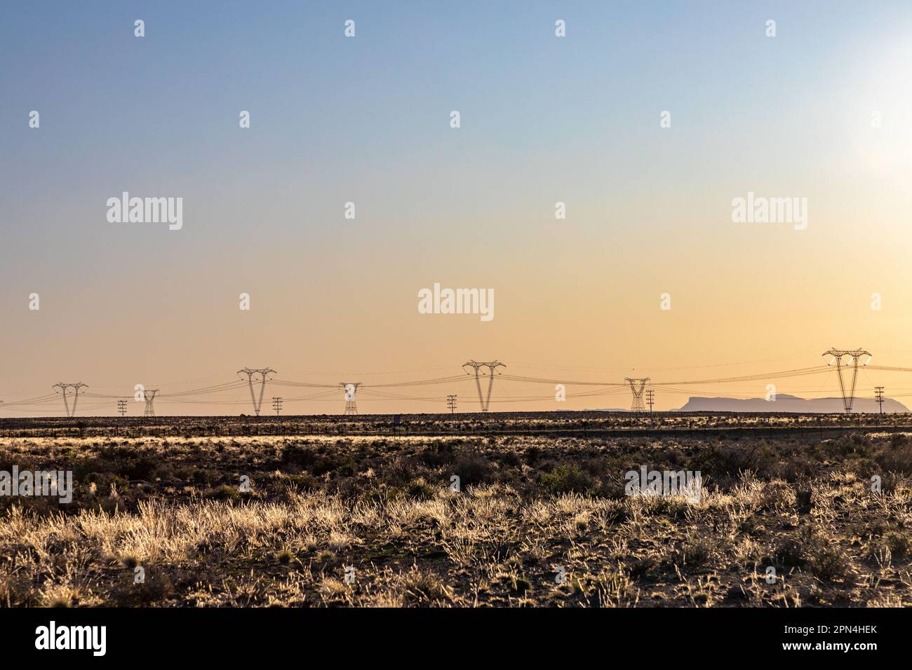Highvoltage power lines at sunset, high voltage electric transmission