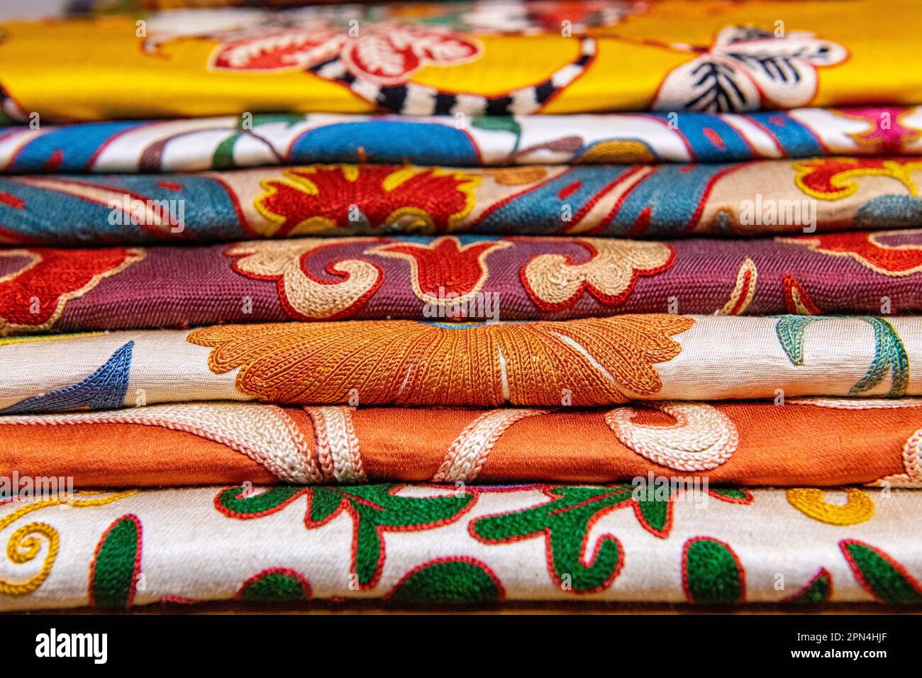 Beautiful fabrics neatly stacked Stock Photo