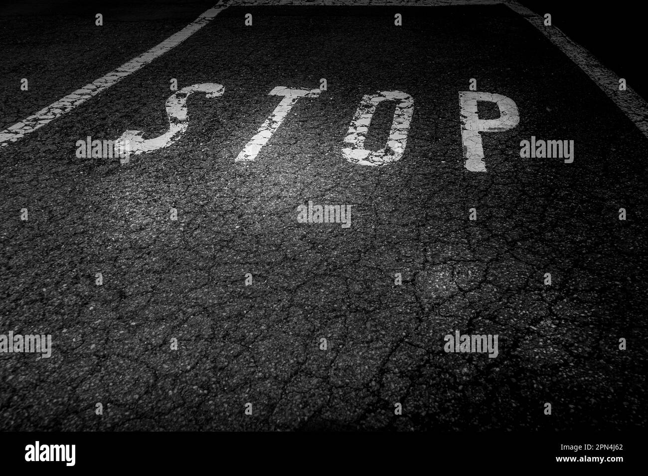 Stop sign on the asphalt road. black and white traffic signal. Stock Photo