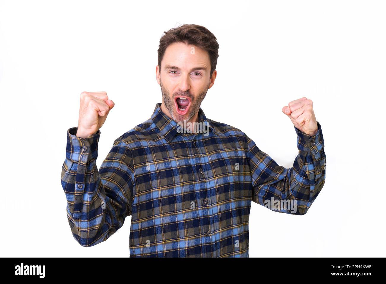 Adult hipster male model posing in a plait shirt cheering and celebrating Stock Photo