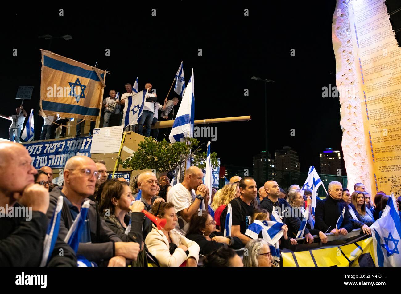 Israel. 15th Apr, 2023. Warriors of the 73' Yom Kippur War wave an authentic old Israeli flag used at the battle as they ride a tank model next to a giant copy of the Israeli Declaration of Independence in a protestation against the legal overhaul in Netanya. Apr 15th 2023. (Matan Golan/Sipa USA). Credit: Sipa USA/Alamy Live News Stock Photo