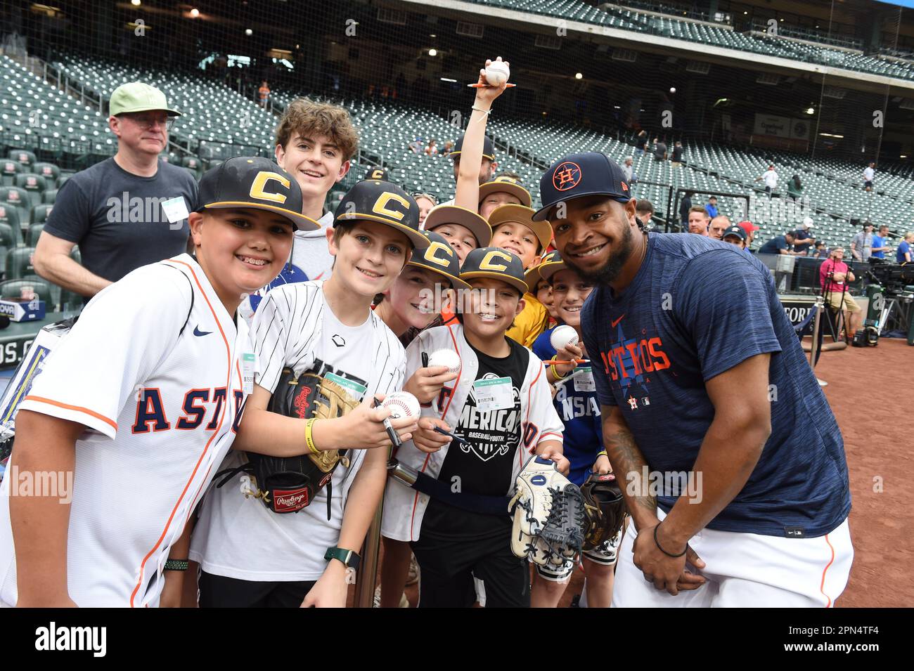 Houston Astros right fielder Corey Julks (9) poses with young baseball