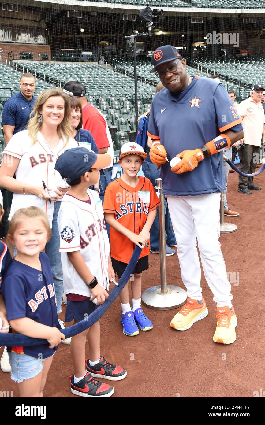 Houston Astros manager Dusty Baker Jr. (12) signs autographs for young fans during the MLB game between the Texas Ranges and the Houston Astros on Fri Stock Photo