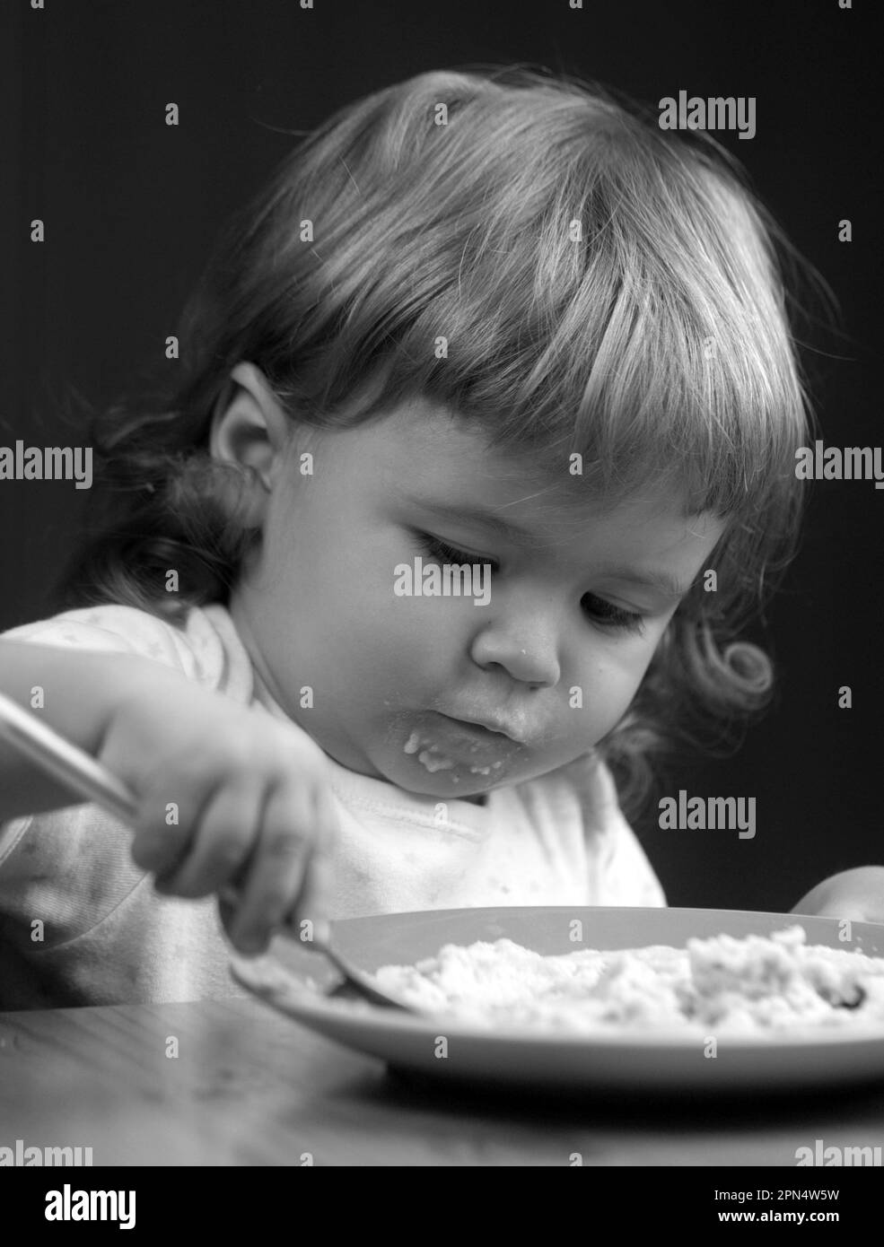 Child eating, nutrition concept. Cute baby face with a spoon and a ...