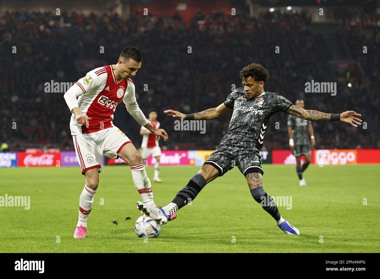 AMSTERDAM - (L-R) Steven Berghuis of Ajax, Jermy Antonisse of FC Emmen during the Dutch premier league match between Ajax Amsterdam and FC Emmen at the Johan Cruijff ArenA on April 16, 2023 in Amsterdam, Netherlands. ANP MAURICE VAN STONE Stock Photo