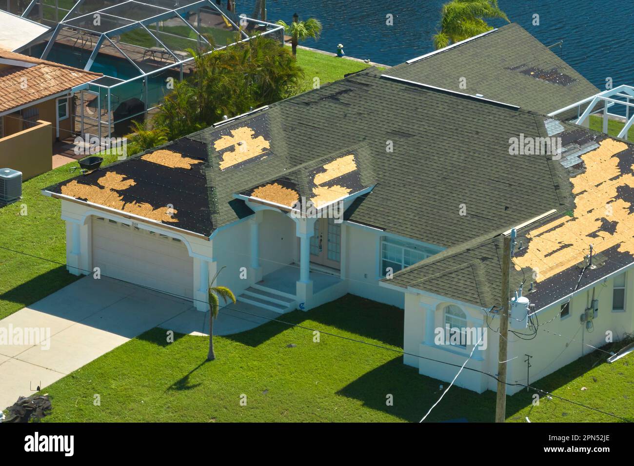 Hurricane Ian destroyed house roof in Florida residential area. Natural ...