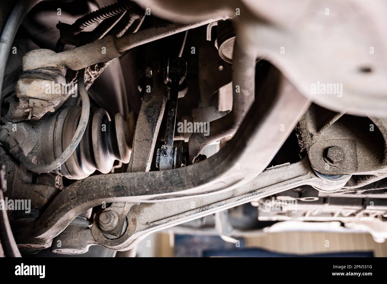 Close-up of car parts on a lift in a garage Stock Photo - Alamy
