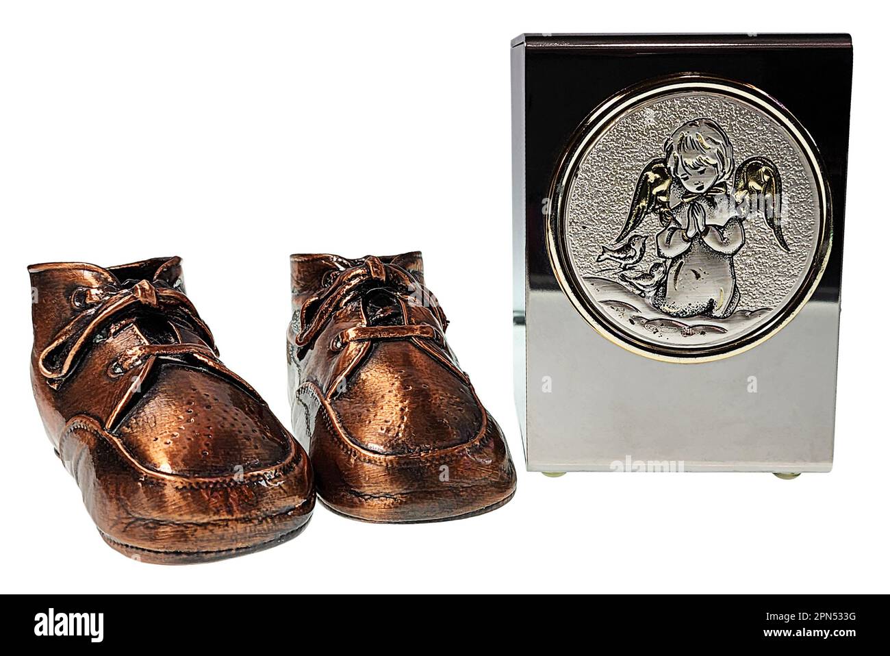 Bronzed baby shoes to memorialize childhood and a baby urn Stock Photo