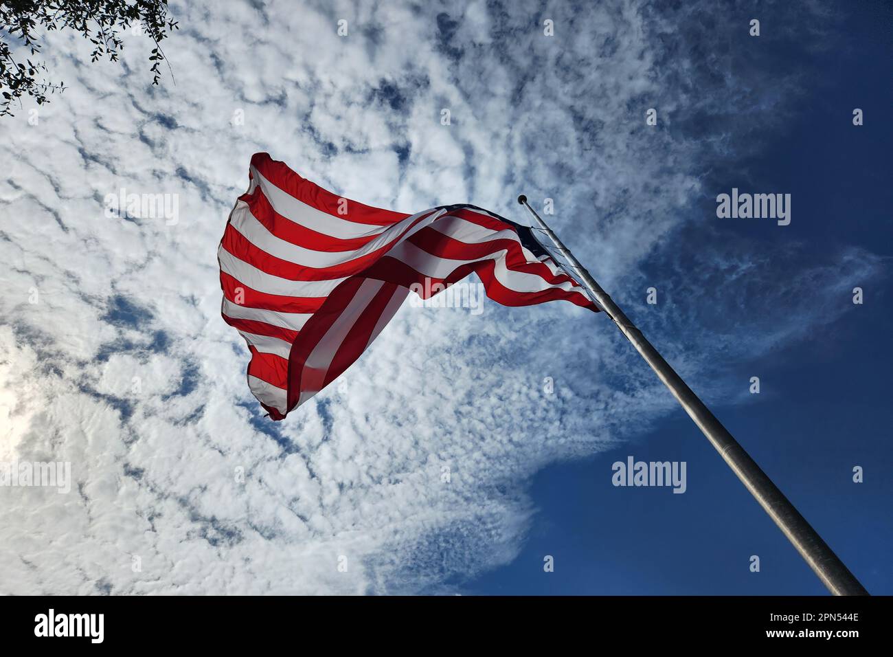 USA national flag waving on wind against blue sky. American stars and ...