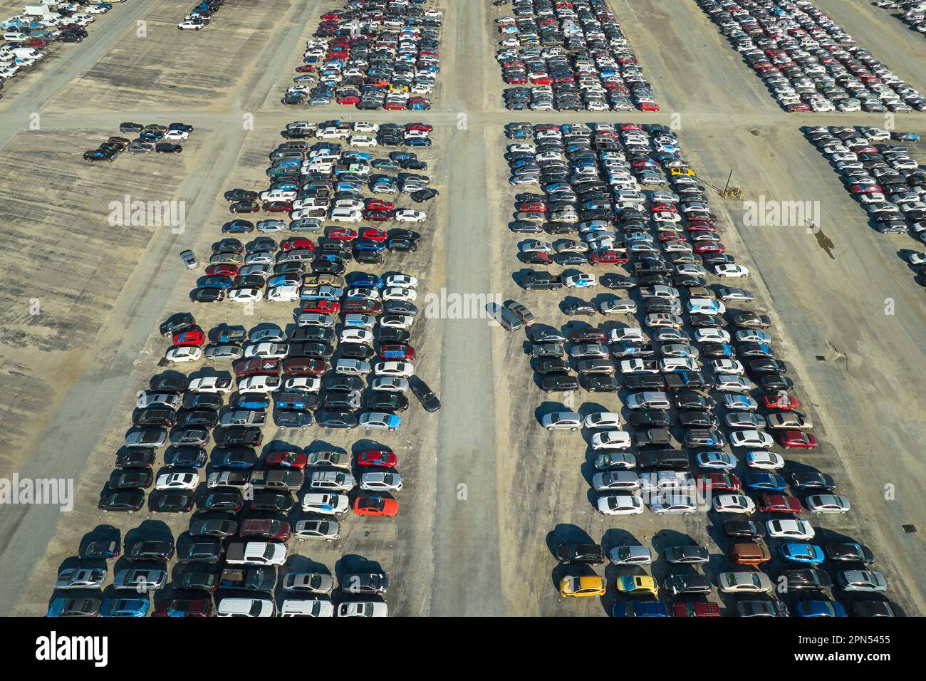 Used damaged cars on auction reseller company big parking lot ready for