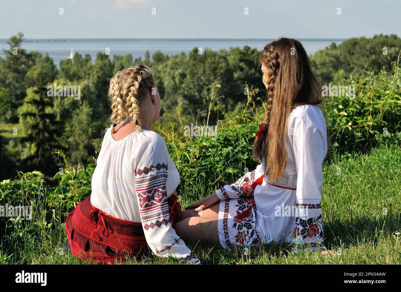 outdoor portrait of two young ukrainian women in traditional ukrainian clothes Stock Photo