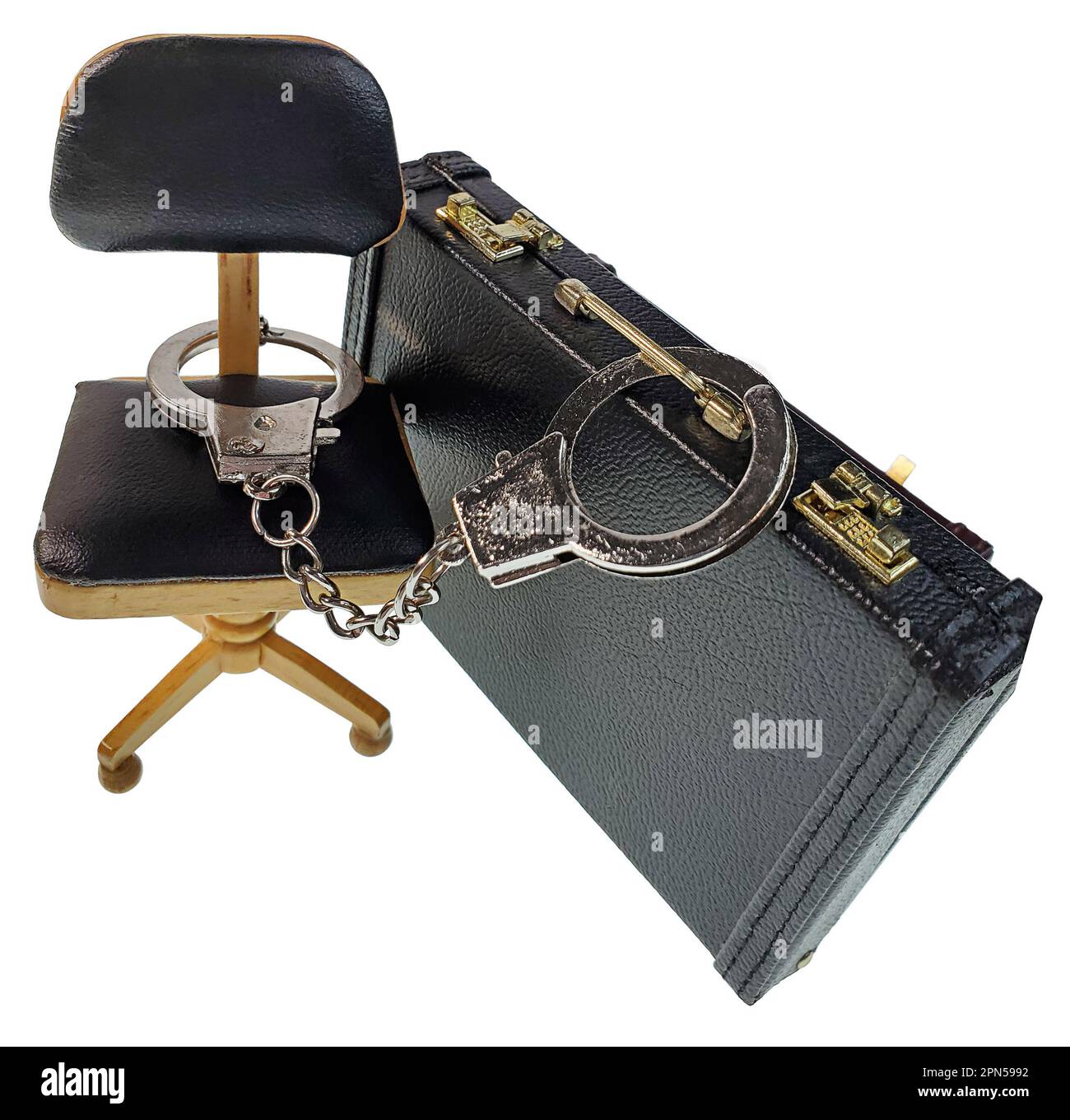 Leather briefcase and office chair handcuffed together showing chained to work Stock Photo