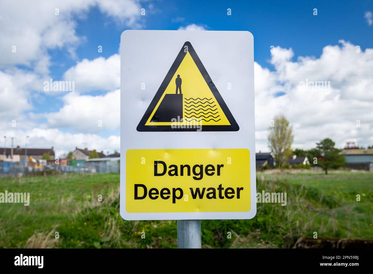 Danger Deep Water warning sign close up by rural waterway river stream