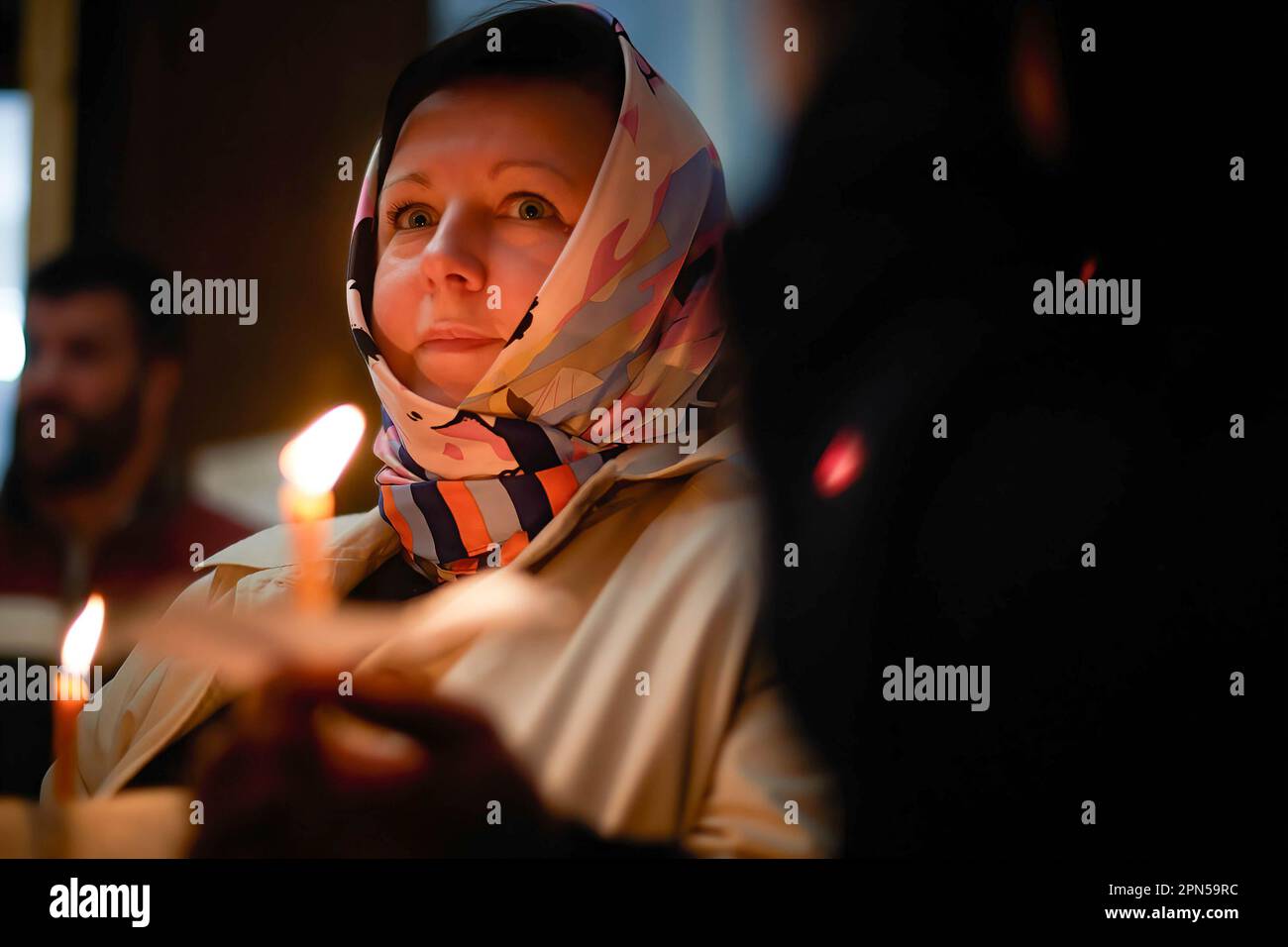 April 15, 2023, Biarritz, France: Several faithful with lit candles in ...