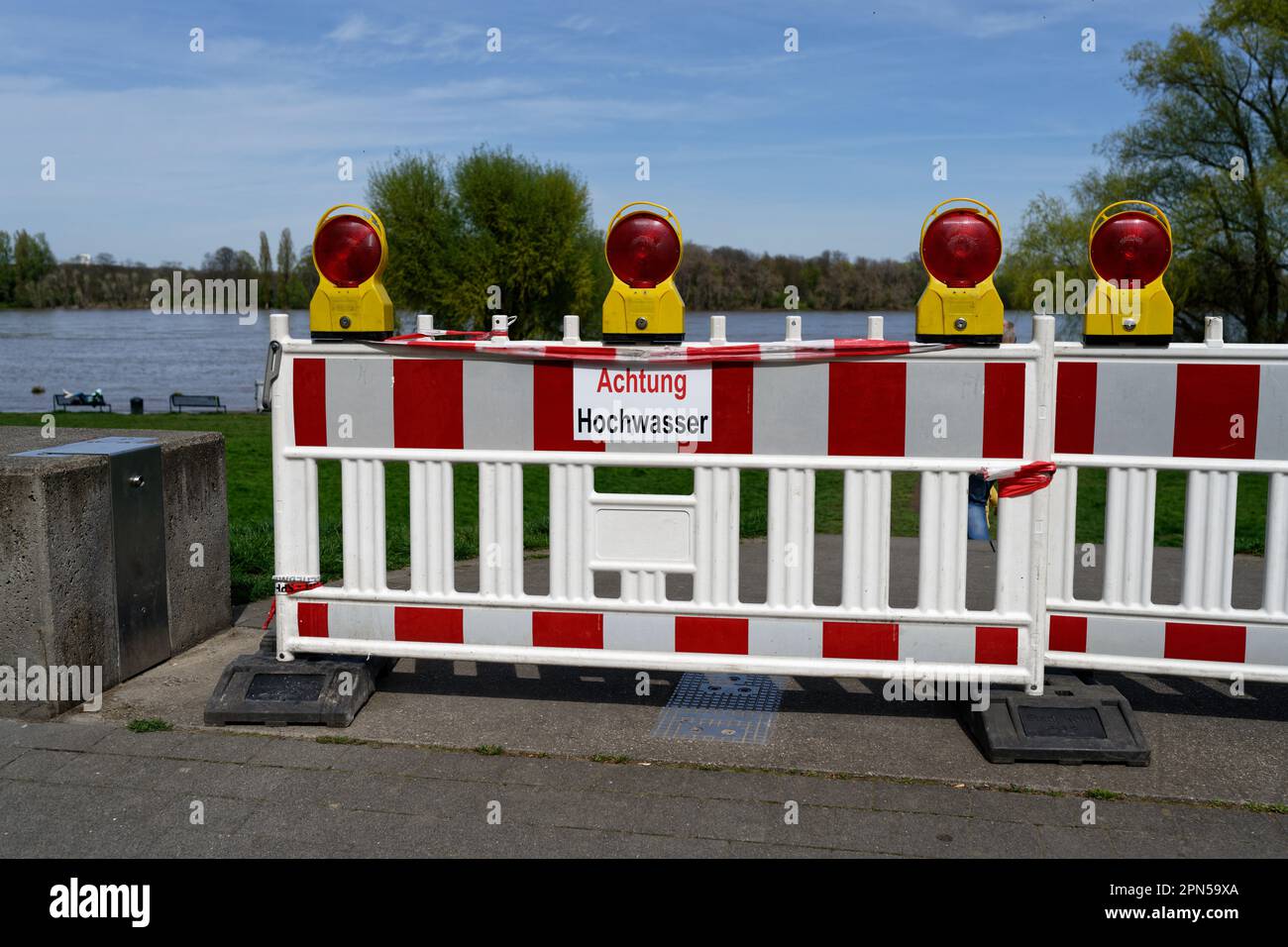 Barrier beacon with warning lamp and inscription ' Achtung Hochwasser' (warning of high water) on the rhine near cologne Stock Photo