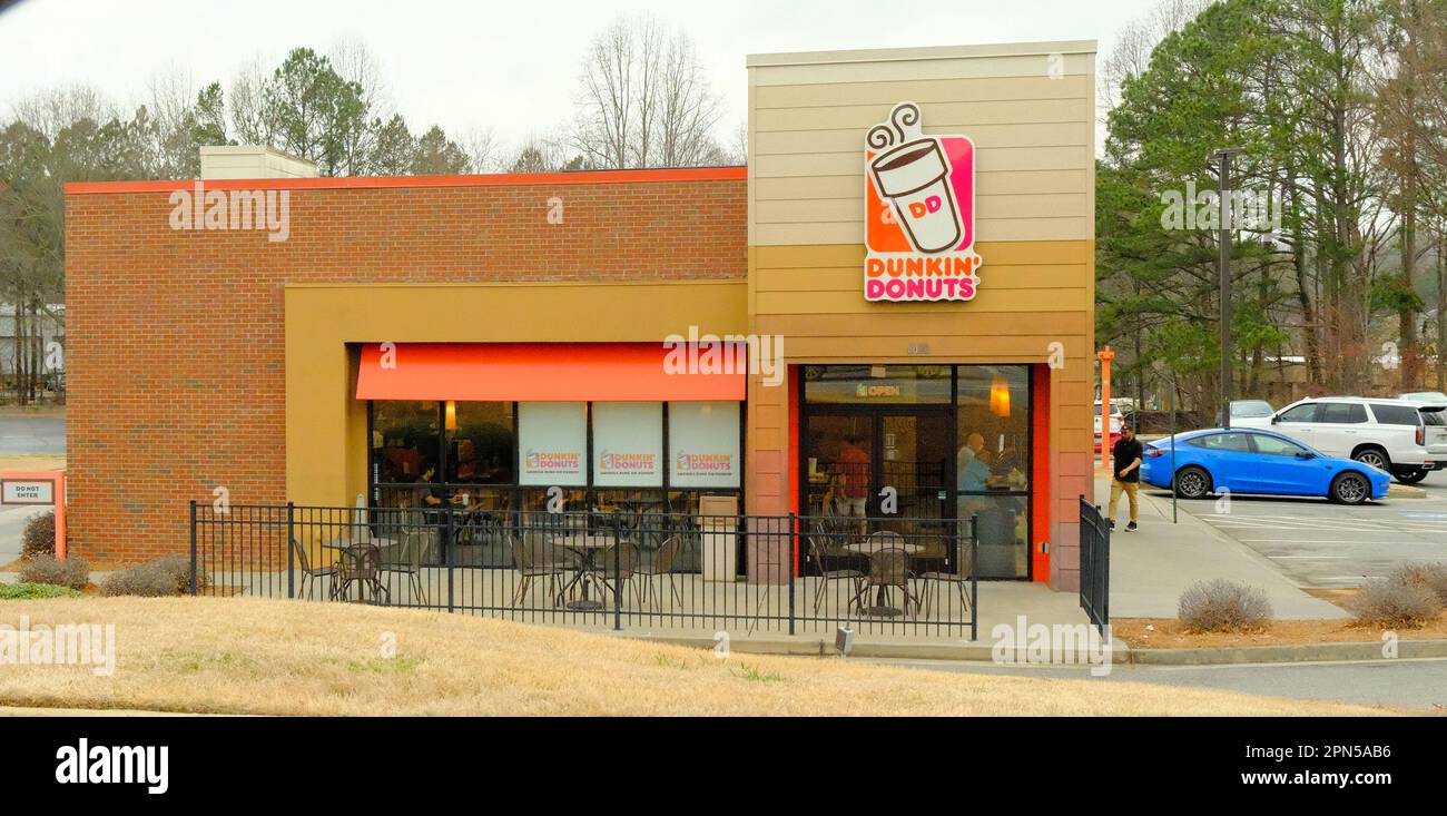 DUNWOODY, GEORGIA- February 23, 2023: Dunkin' Donuts is an American multinational coffeehouse and donut company. It was founded by William Rosenberg i Stock Photo