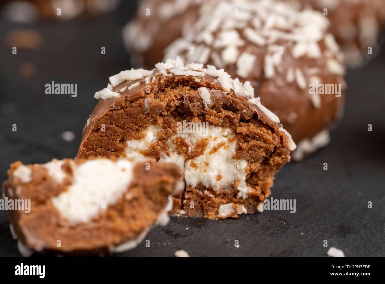 Chocolate candies with milk coconut filling and coconut chips